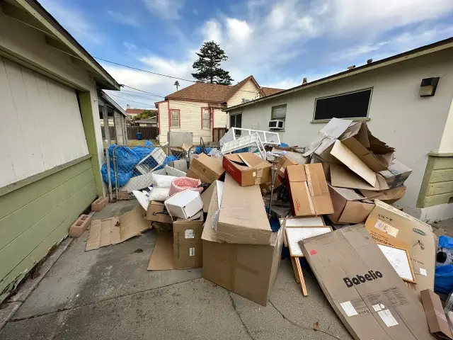 scattered boxes with junk in yard